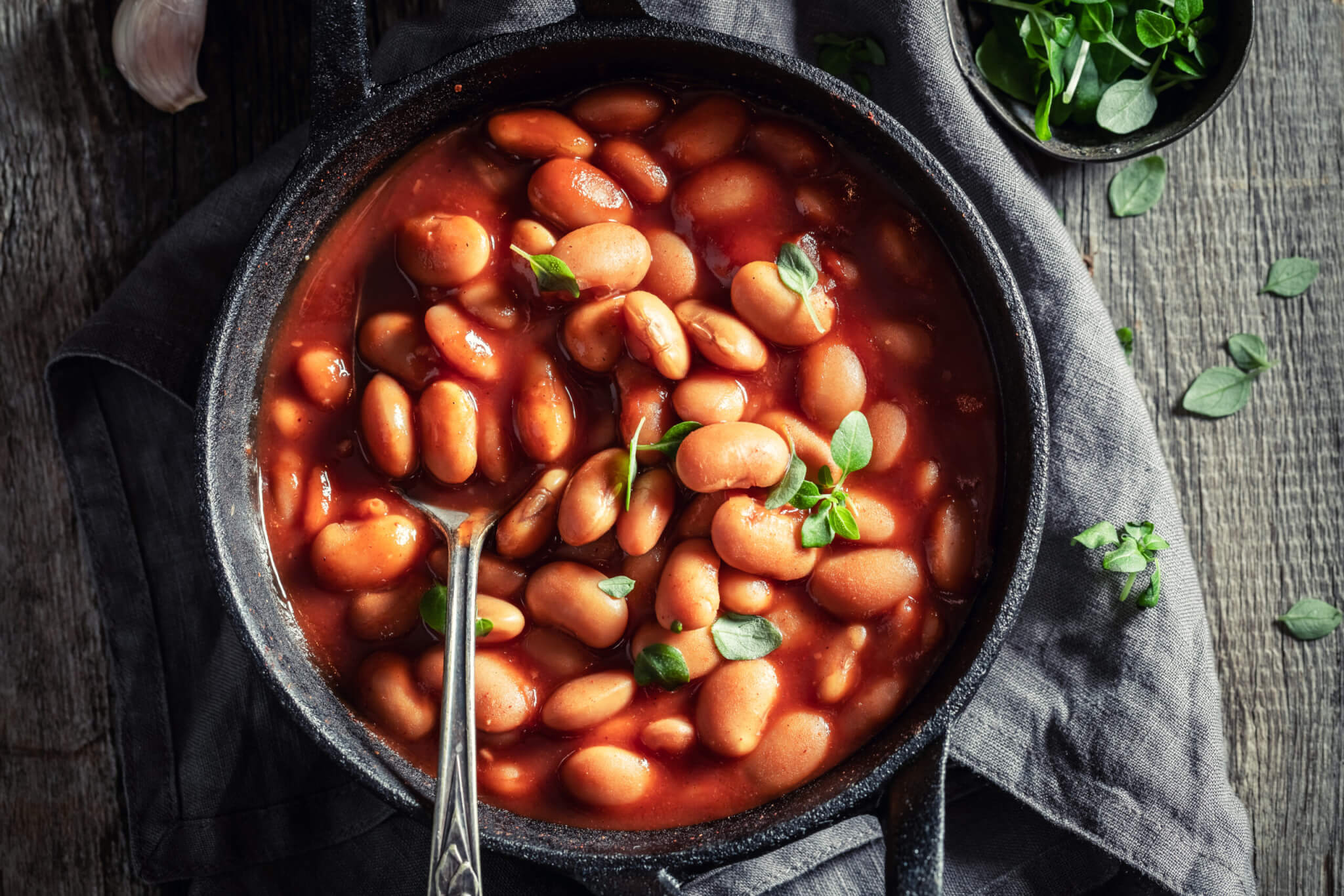 Tasty baked beans with garlic and fresh tomatoes