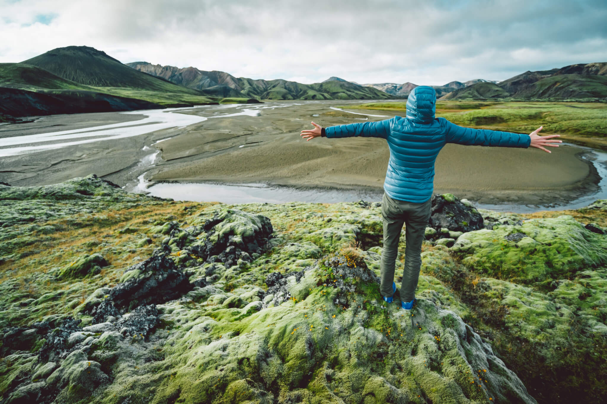 young woman looking at majestic icelandic landscape