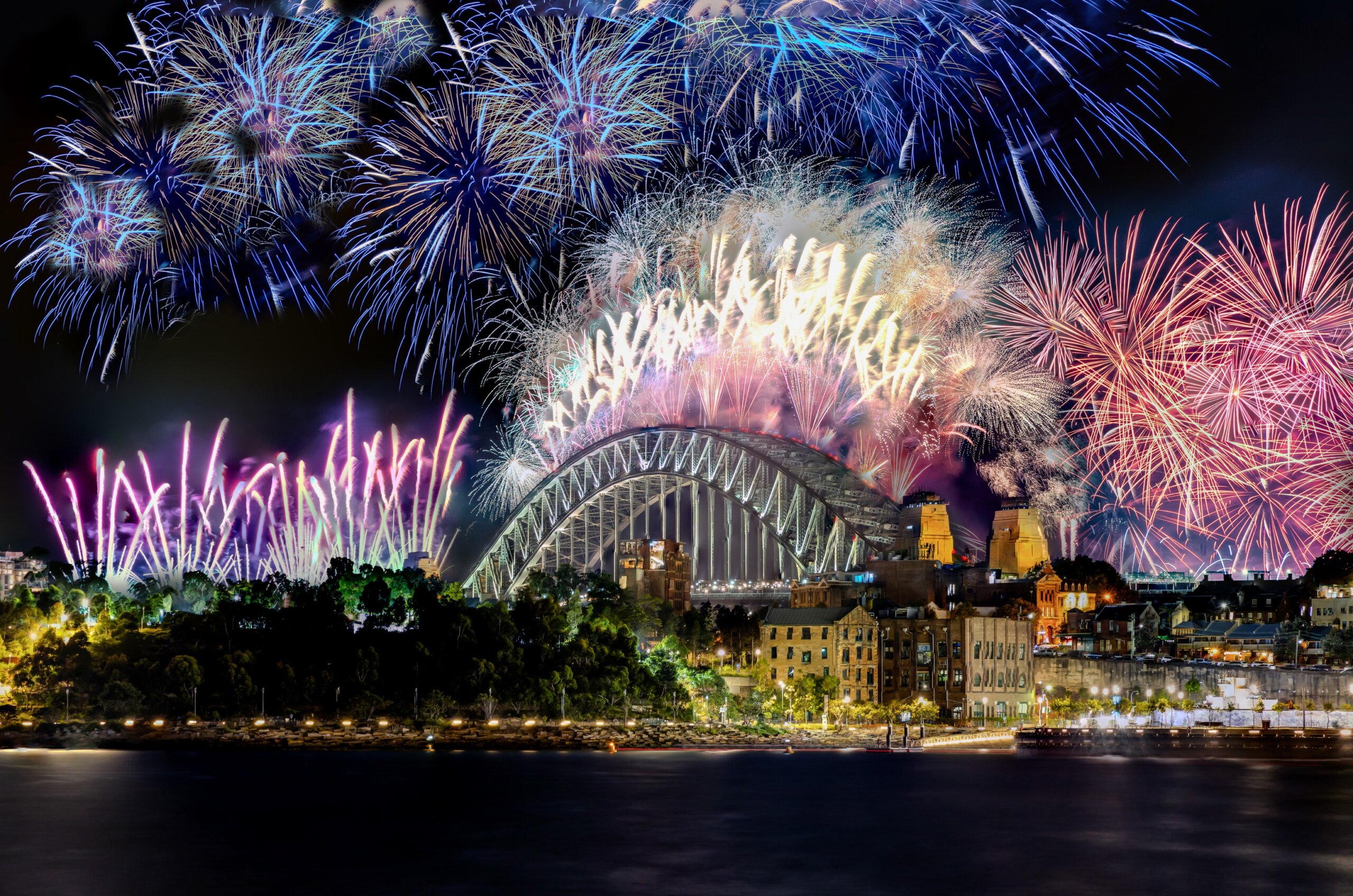 Sydney Harbour Bridge New Years Eve fireworks, colourful NYE fire works lighting the night skies with vivid multi colours NSW Australia.

