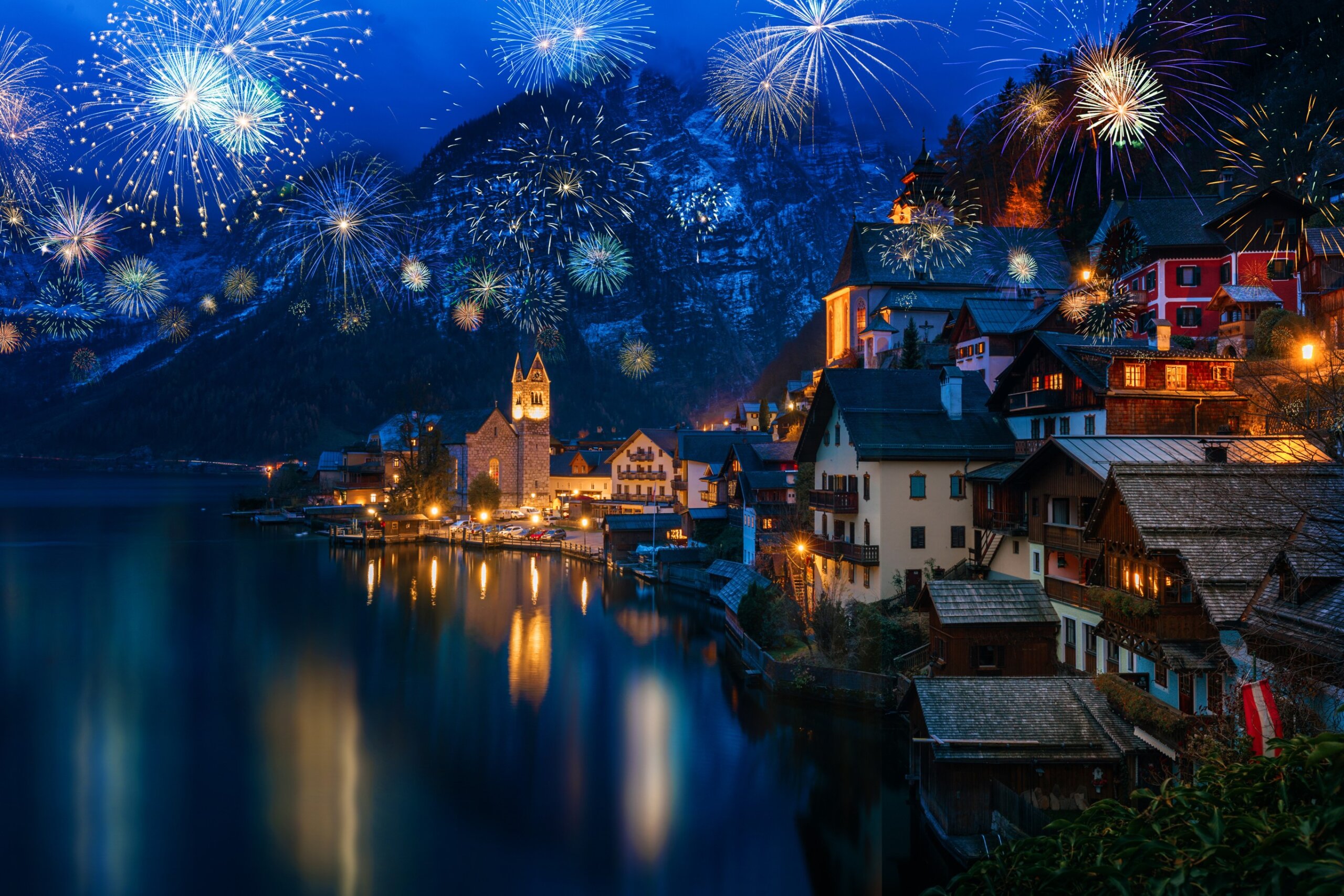 Hallstatt in Austria celebrating New Years Eve with flashing colorful fireworks
