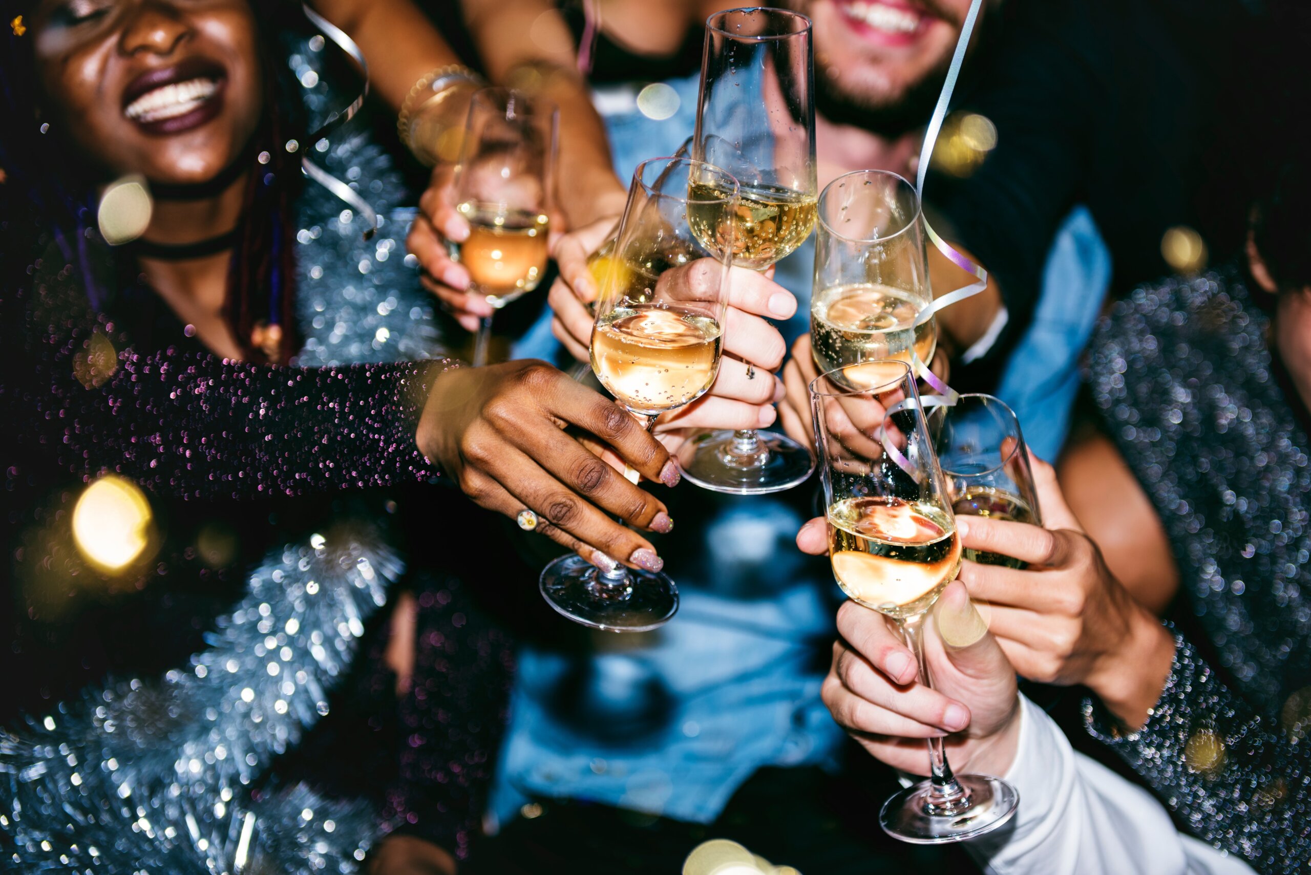 Group of friends toasting with champagne at a New Year’s Eve party