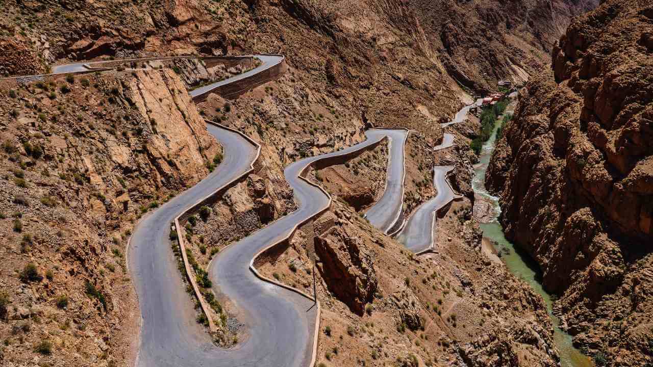 an aerial view of a winding road in the mountains