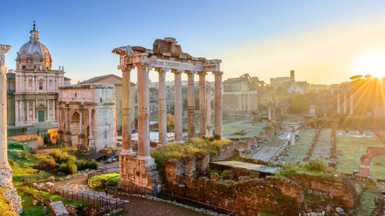 the roman forum at sunset in rome, italy