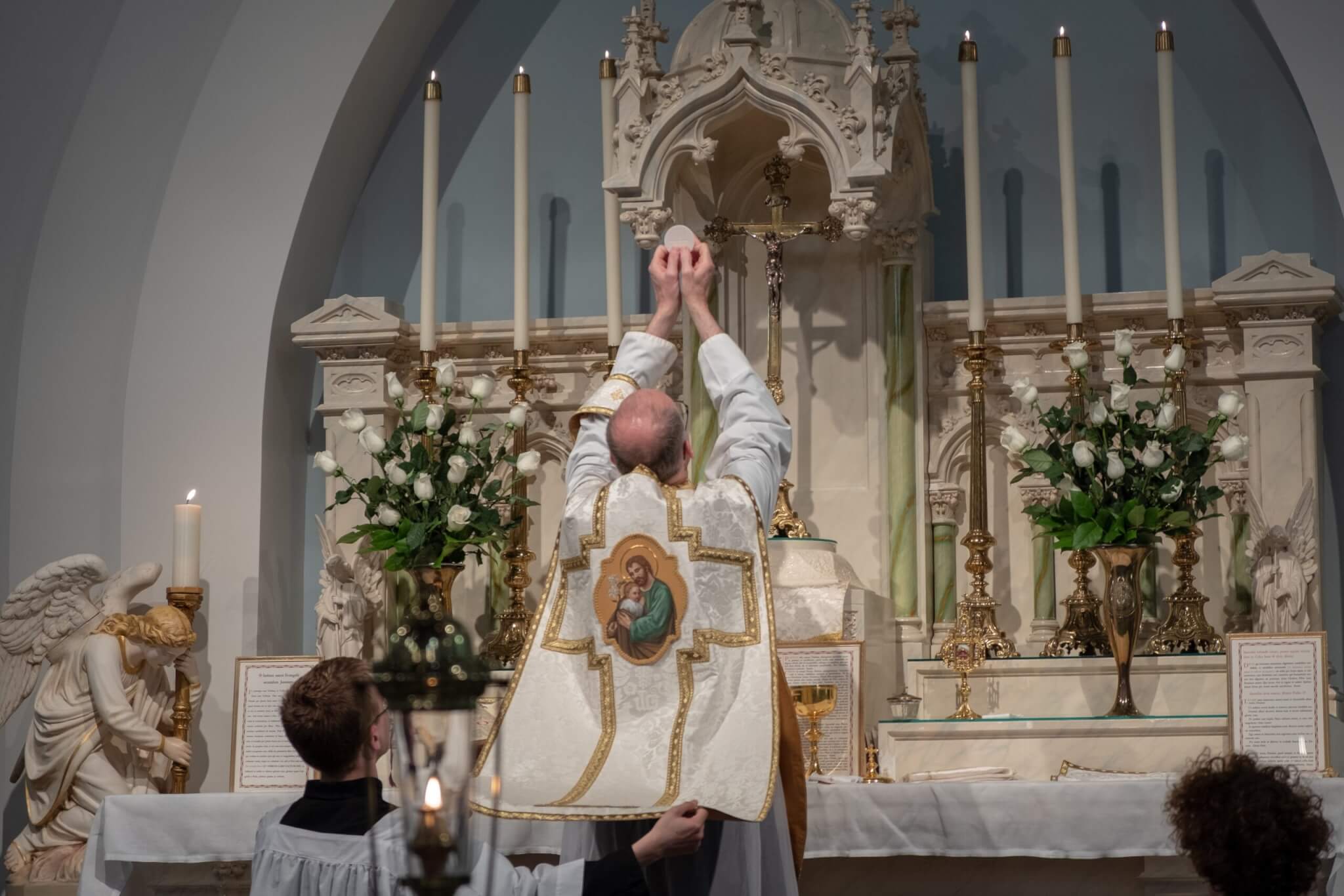 A catholic priest during the consecration at mass