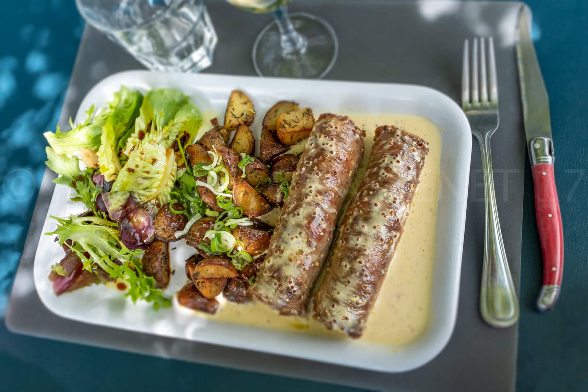 Andouillette, lyonnaise sausage, french food on blue background
