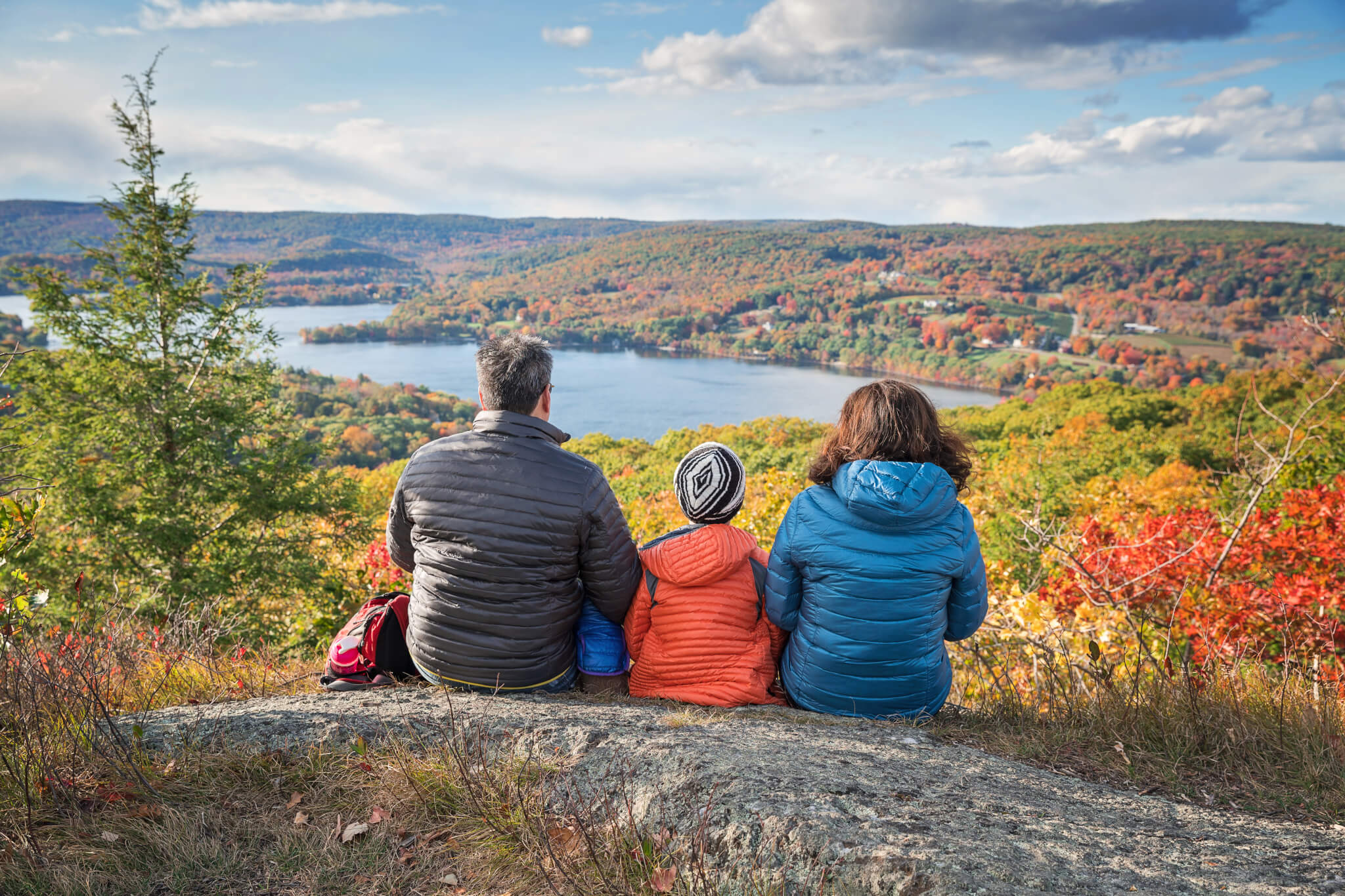 family taking in a scenic spot in the fall in New England