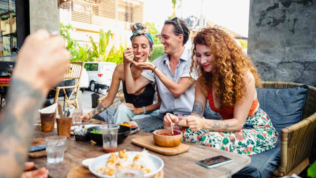 a group of people sitting around a table eating food