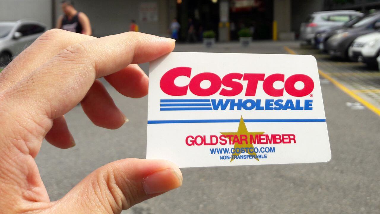 person holding a gold star costco membership card 