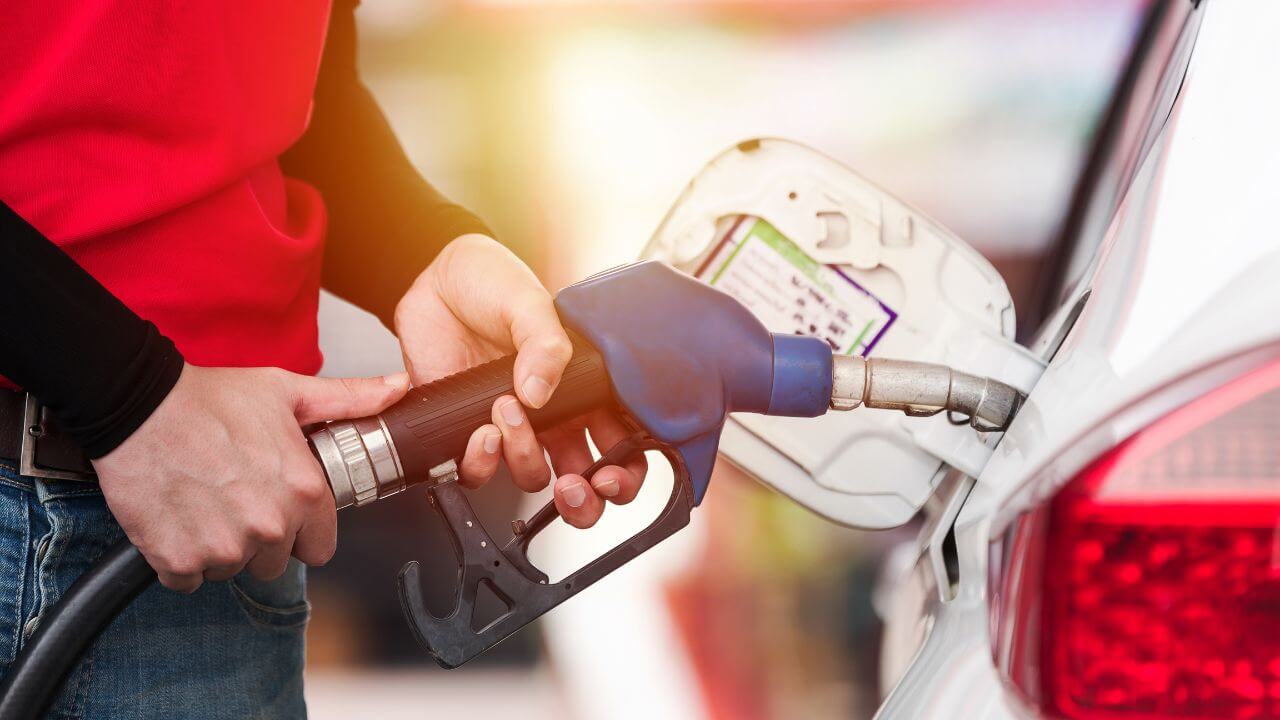 Customer refueling rental car with gas