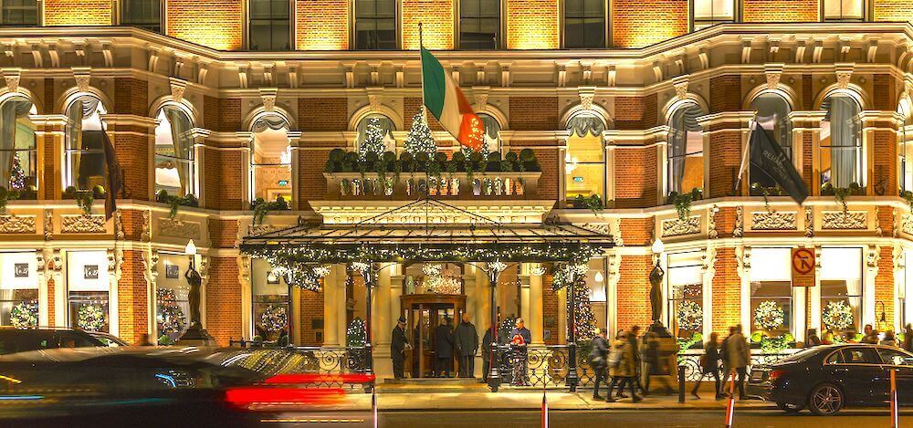 A view of the front of a well know luxury hotel in Dublin lit up at night
