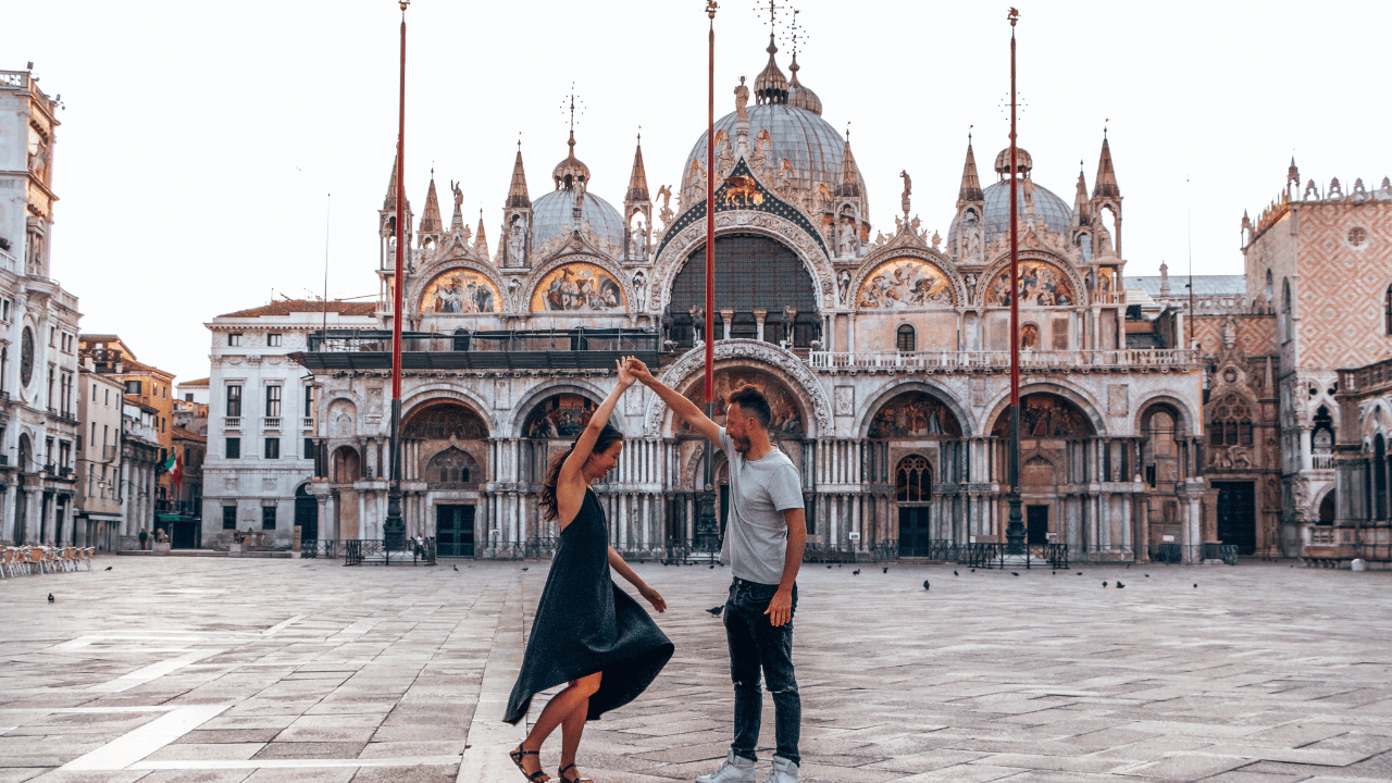 couple happily dancing in basilica plaza in europe 