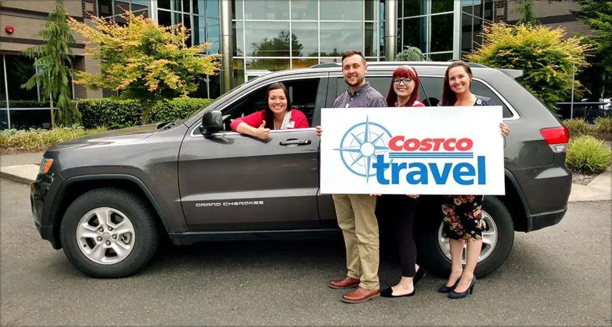 Costco employees holding up a "costco travel sign in front of a jeep cherokee rental car