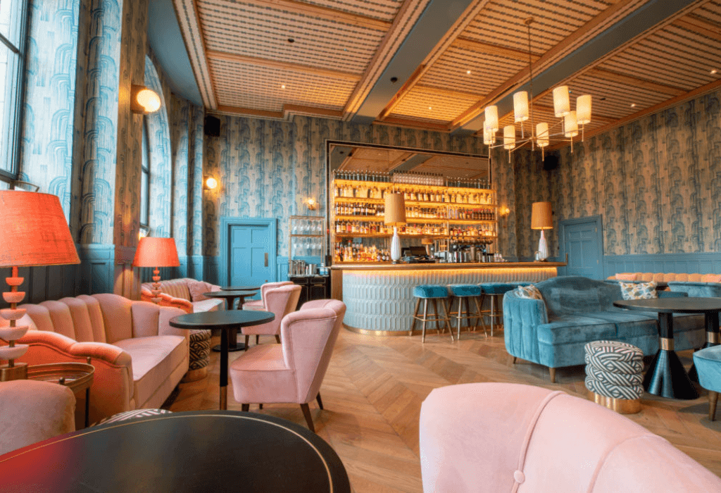 The Clarence hotel bar welcomes guest with vibrant colored furniture and is located in a highly populated area for guest to visit many tourist attractions