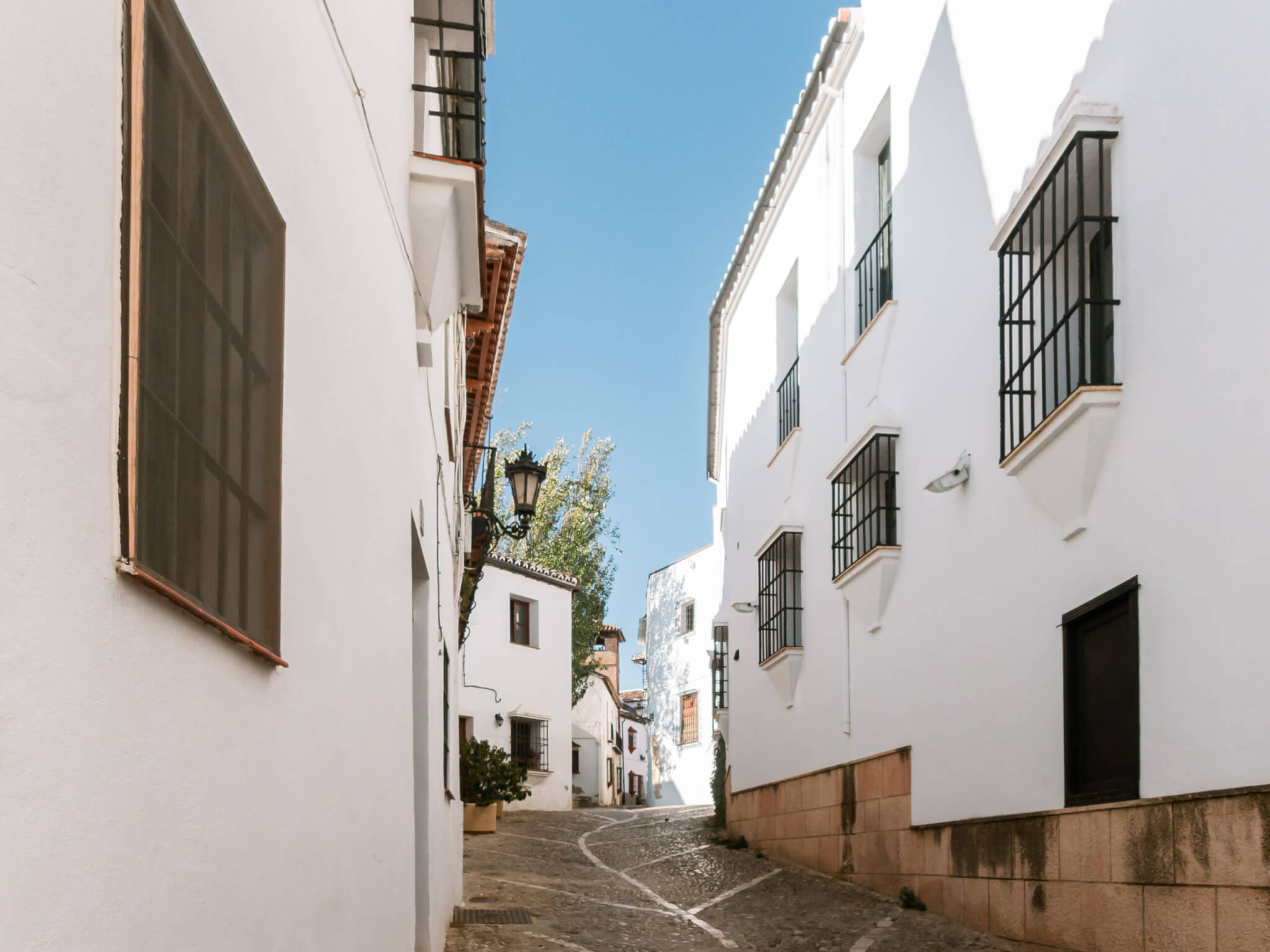 Beautiful street with white houses in the center of Ronda, Andalusia, Spain