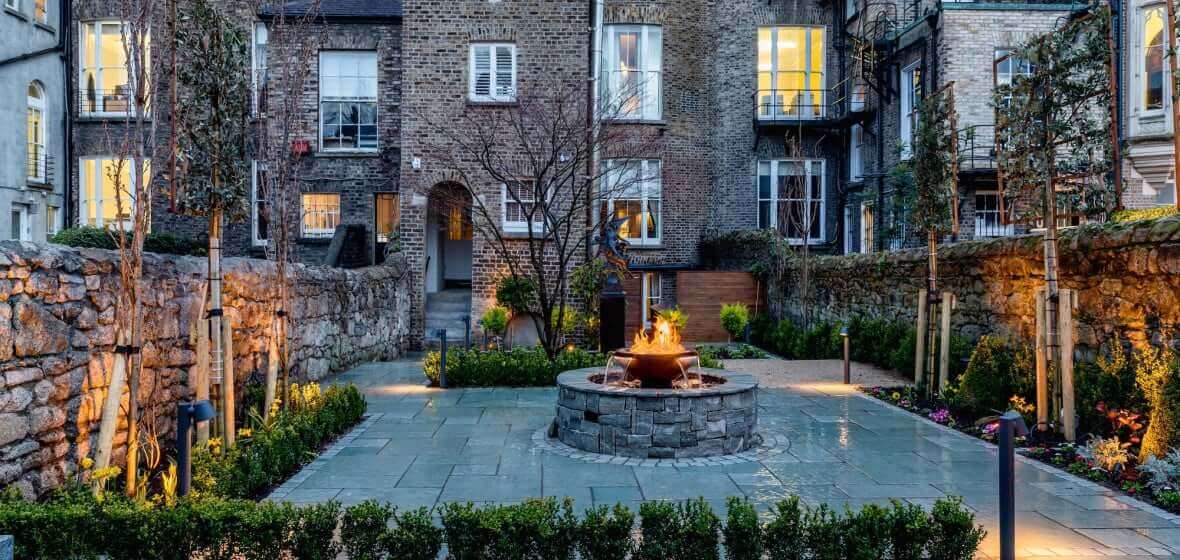 The patio of Number 31, a fireplace fountain is running for an elegant view