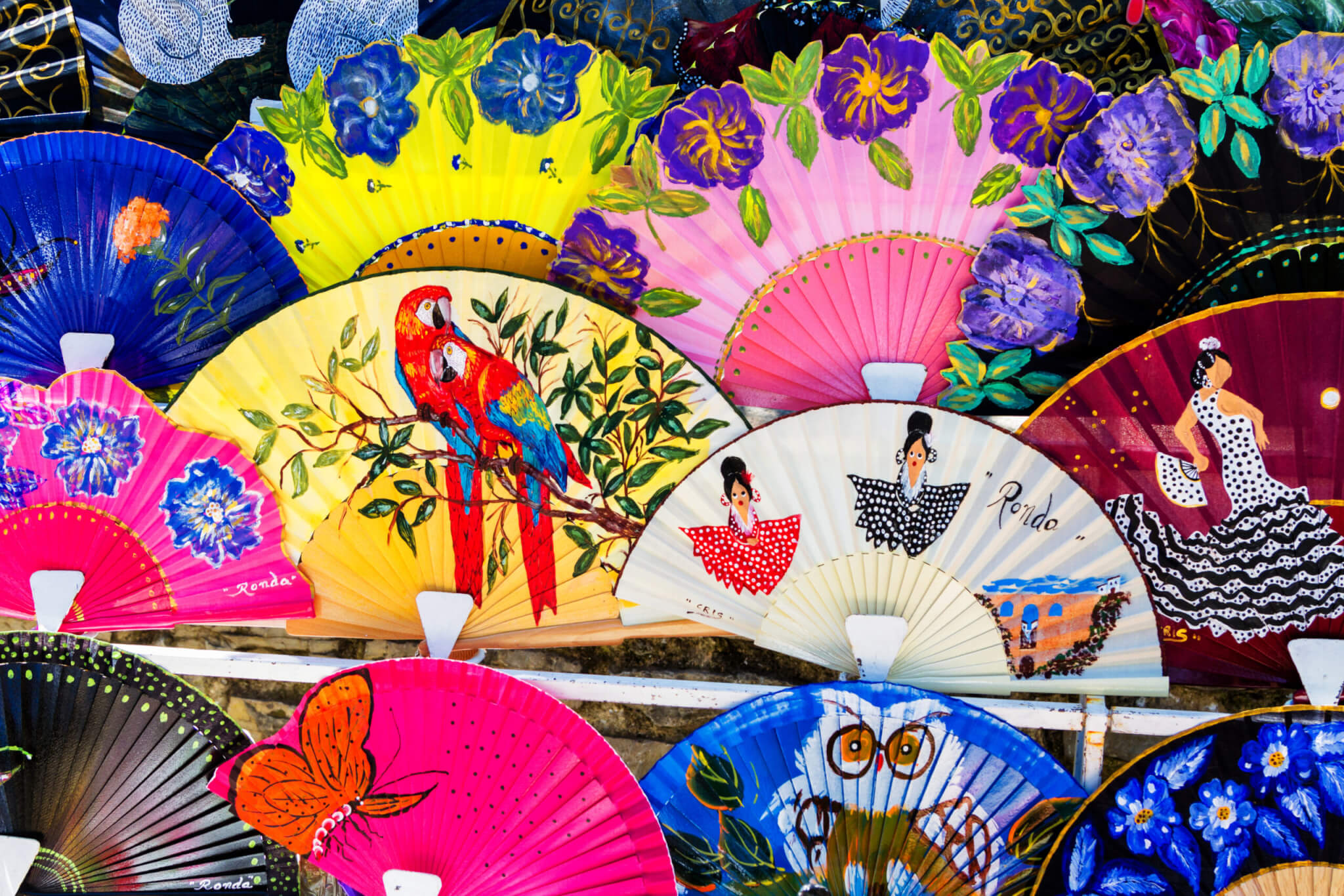 RONDA, SPAIN - MAY 1, 2017: Display of colorful Spanish fans in Ronda - popular tourist destination in Andalusia