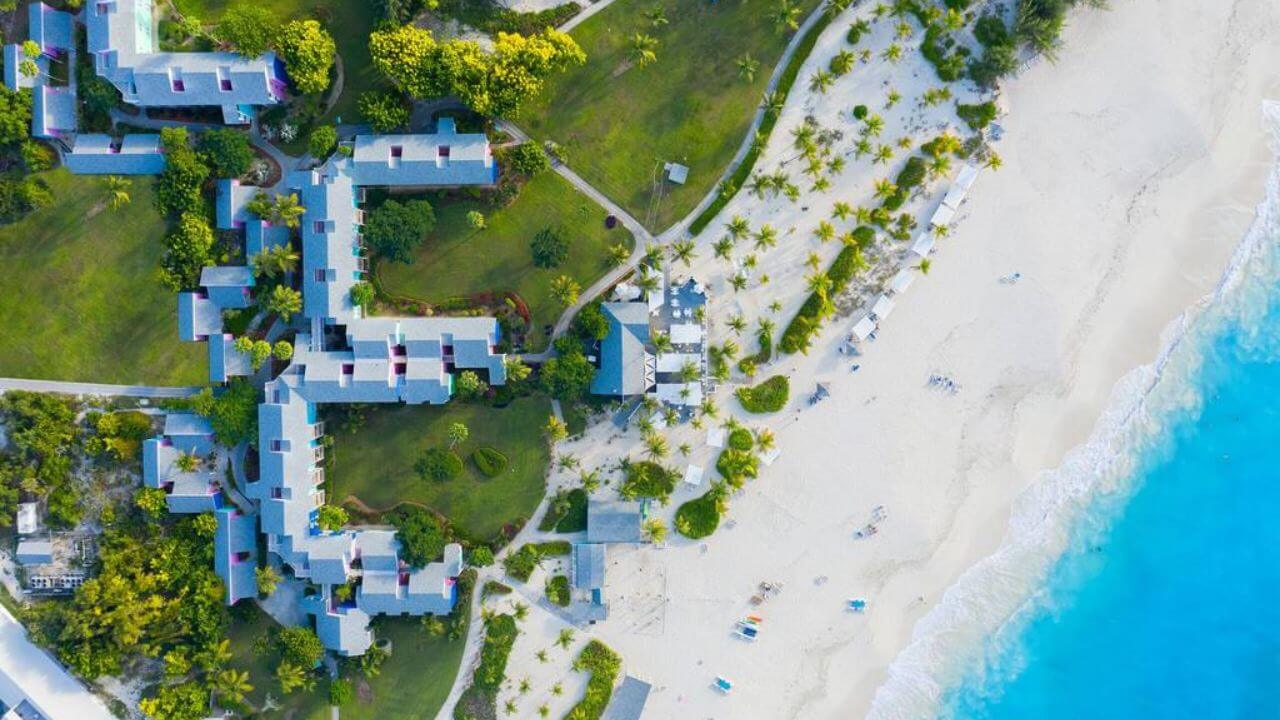 an aerial view of a resort on the beach