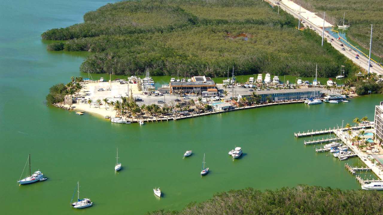 ocean view of gilberts resort with boat in the water and docked near the resort