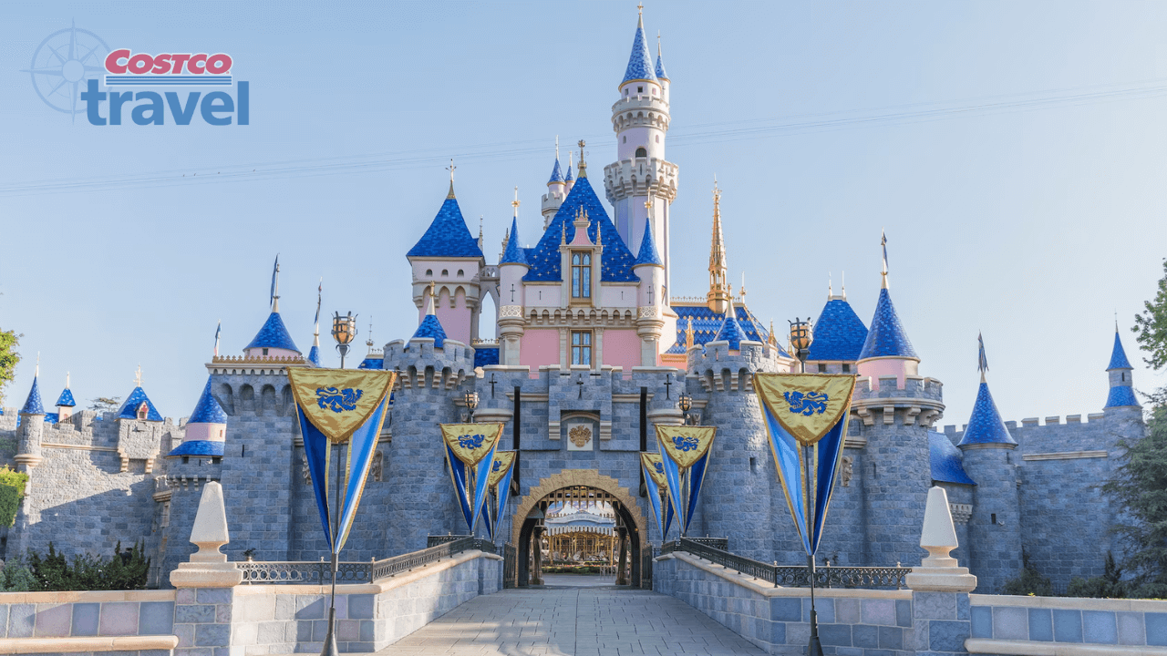 disneyland resort castle during the day time with the costco travel logo in the top left corner