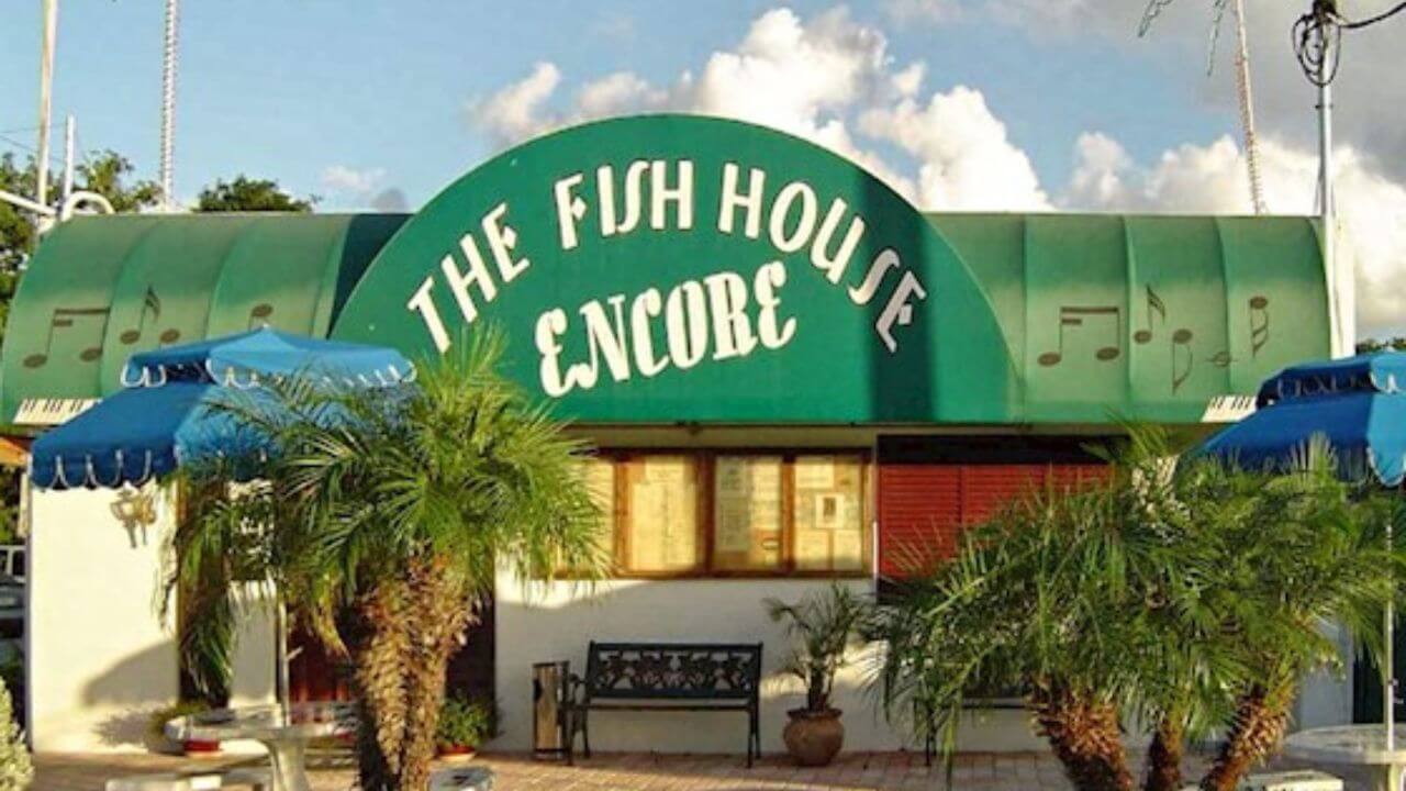 entrance sign on the fish house encore during the daytime 