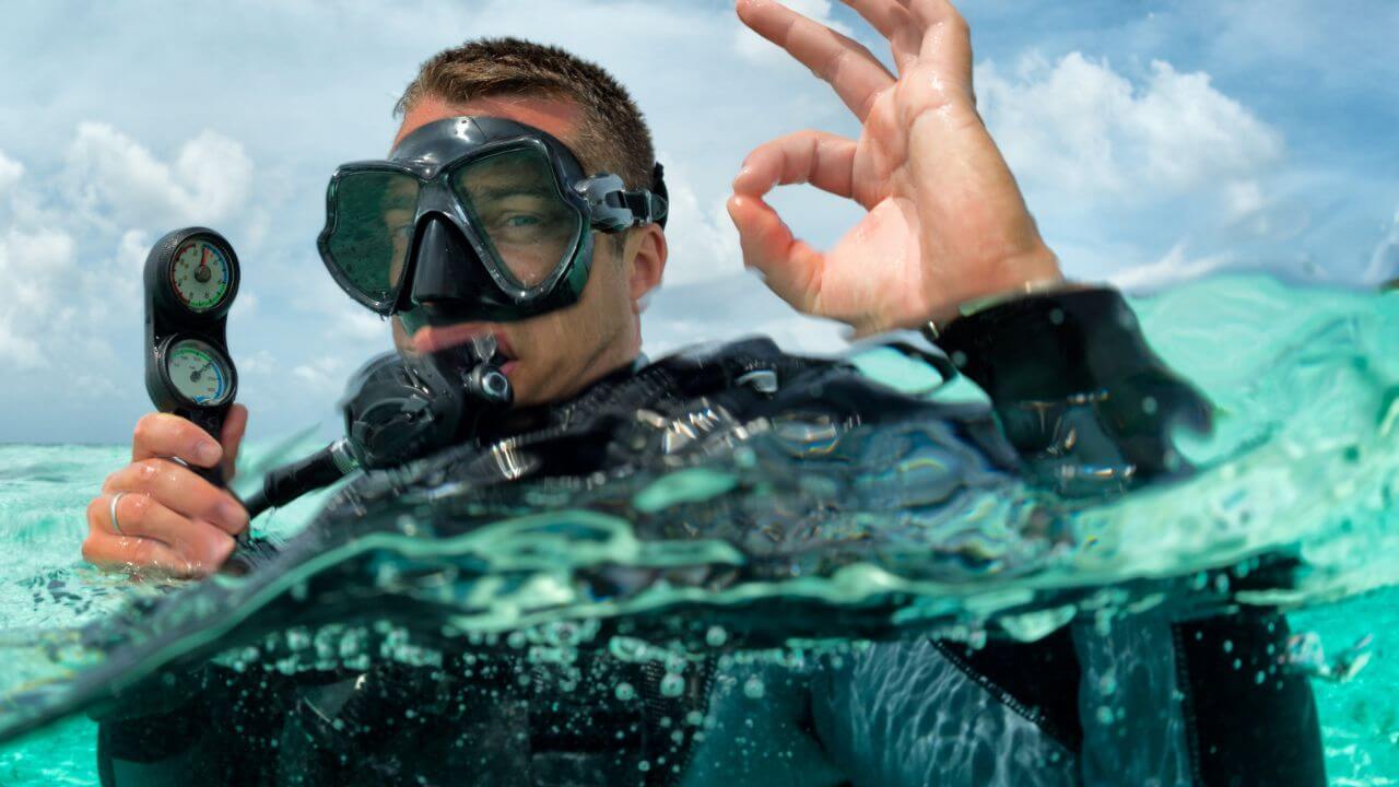 guy in the ocean with scuba diving equipment 