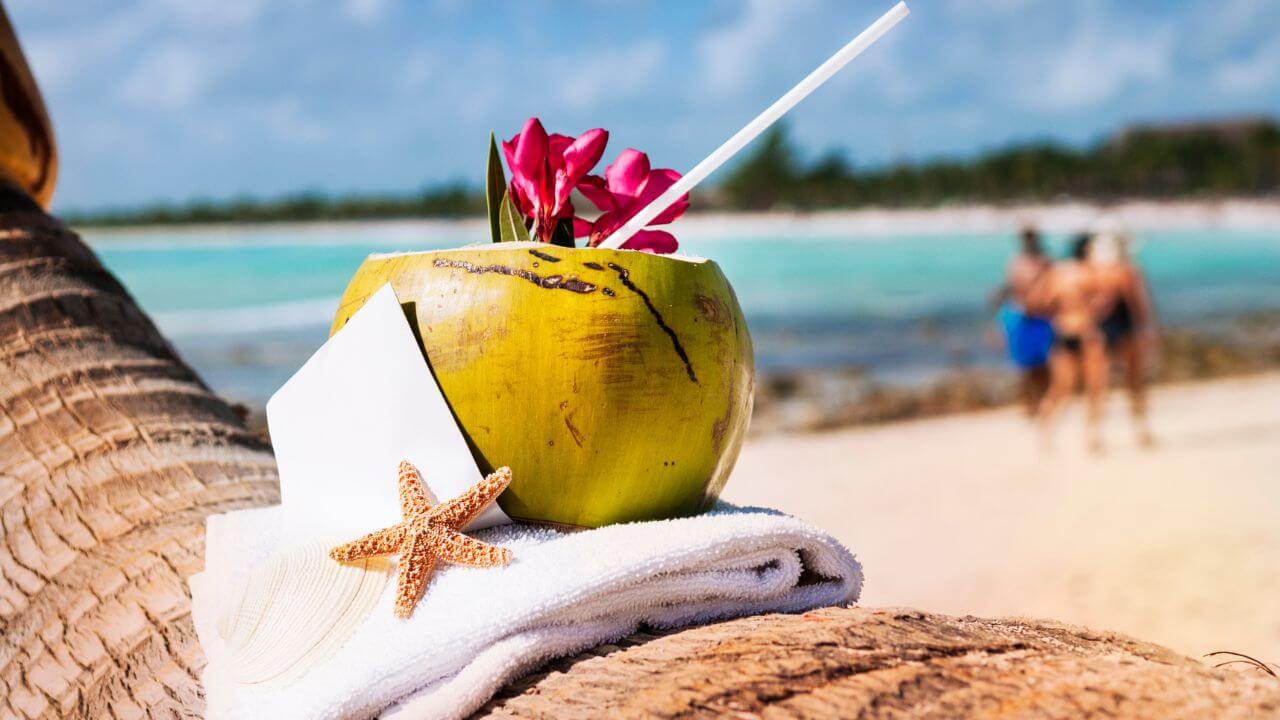 coconut on a towel in front of the Caribbean ocean
