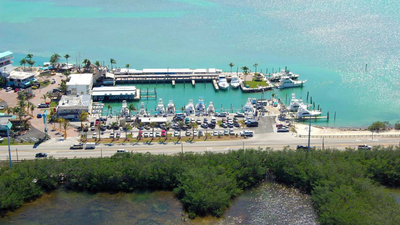 overview of post card inn which is beach front and has a marina and doc attached