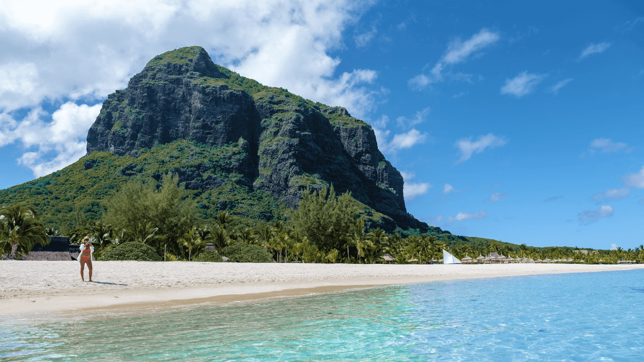  Le Morne Brabant beach with a woman in a bikini taking a picture