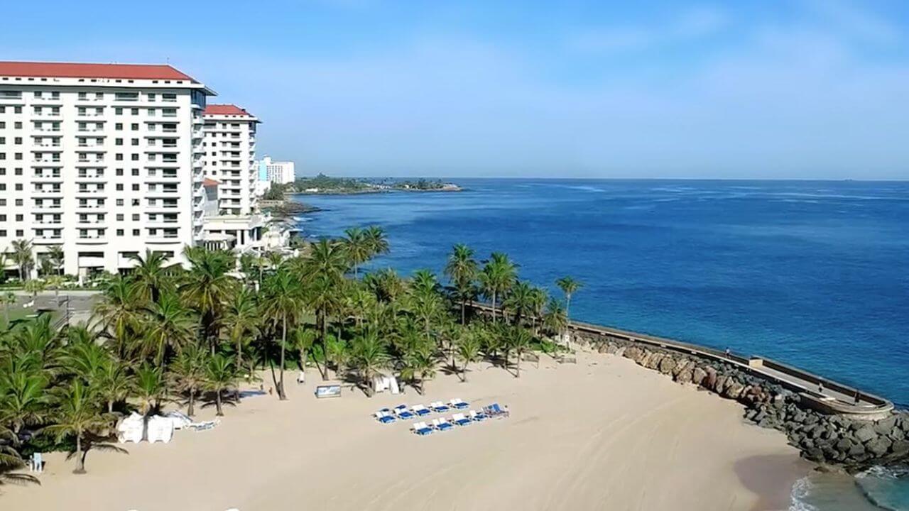 an aerial view of the beach and hotel in puerto rico