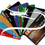 multiple credit cards with airplane overlay