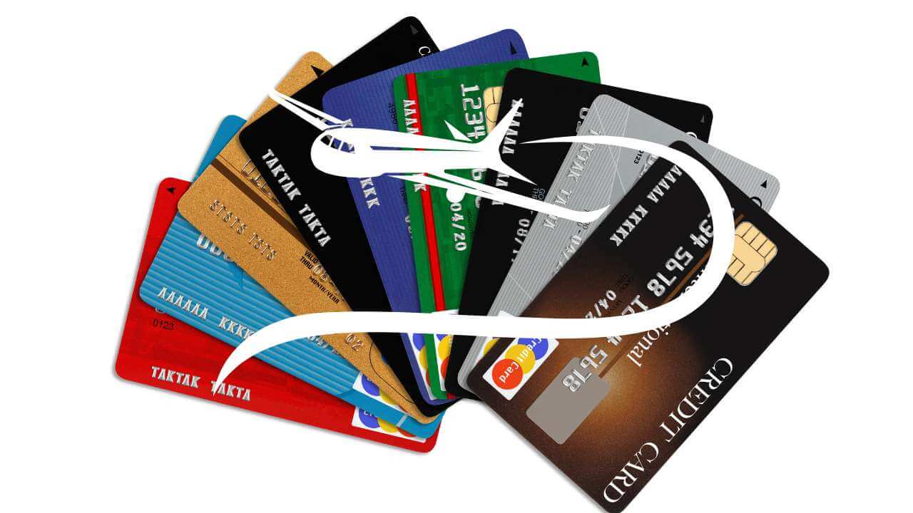 multiple credit cards with airplane overlay