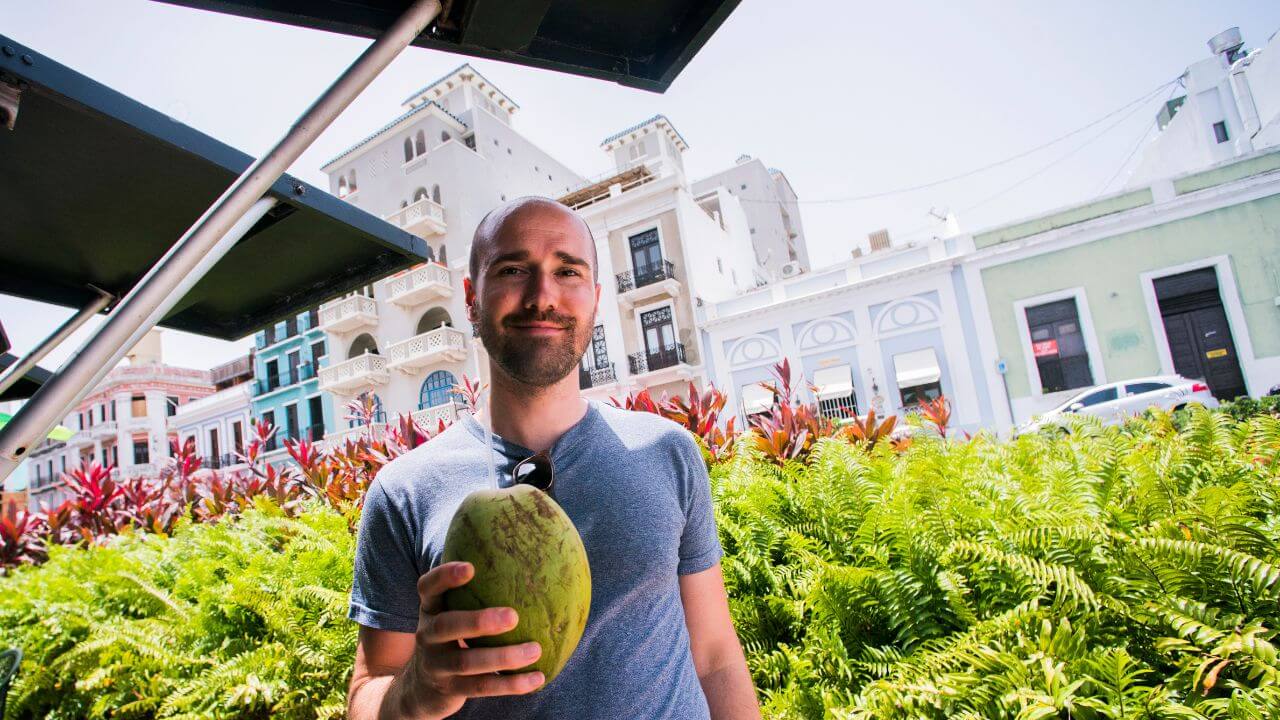 tourist in puerto rico holding a coconut