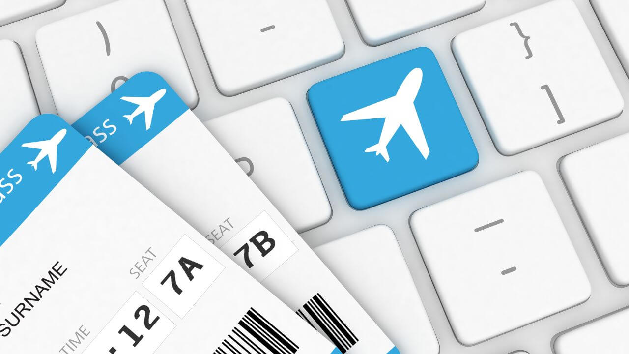 corner of boarding pass and flight icon on keyboard
