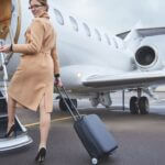 woman boarding a private jet with her carry on