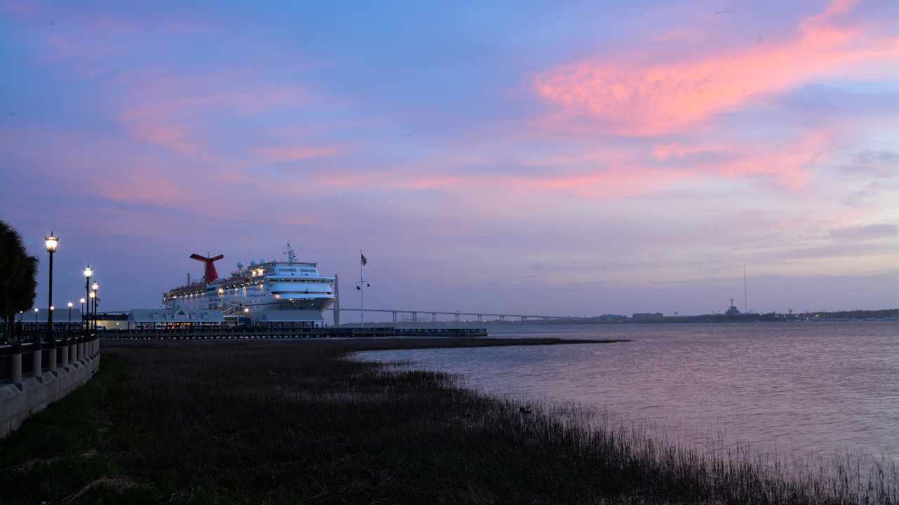 cruise ship off into the distance at sunset in charleston sc