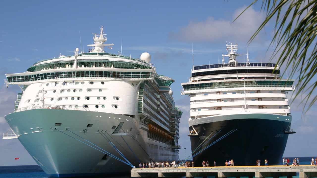 two large cruise ships docked in the caribbean 
