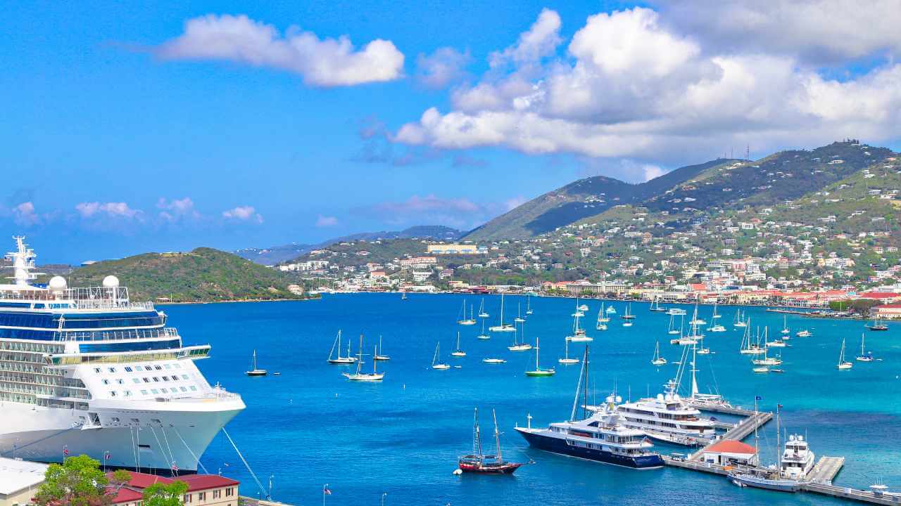 st. thomas view with boats in the ocean and mountains in the background