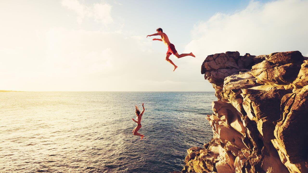two people cliff jumping