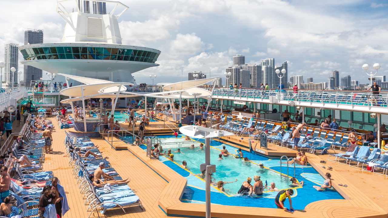 pool deck on a cruise ship with miami city in the background