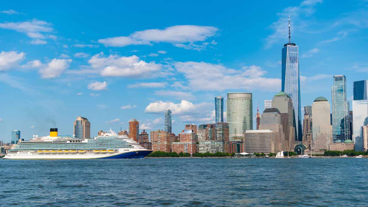 cruise ship with nyc skyline in background