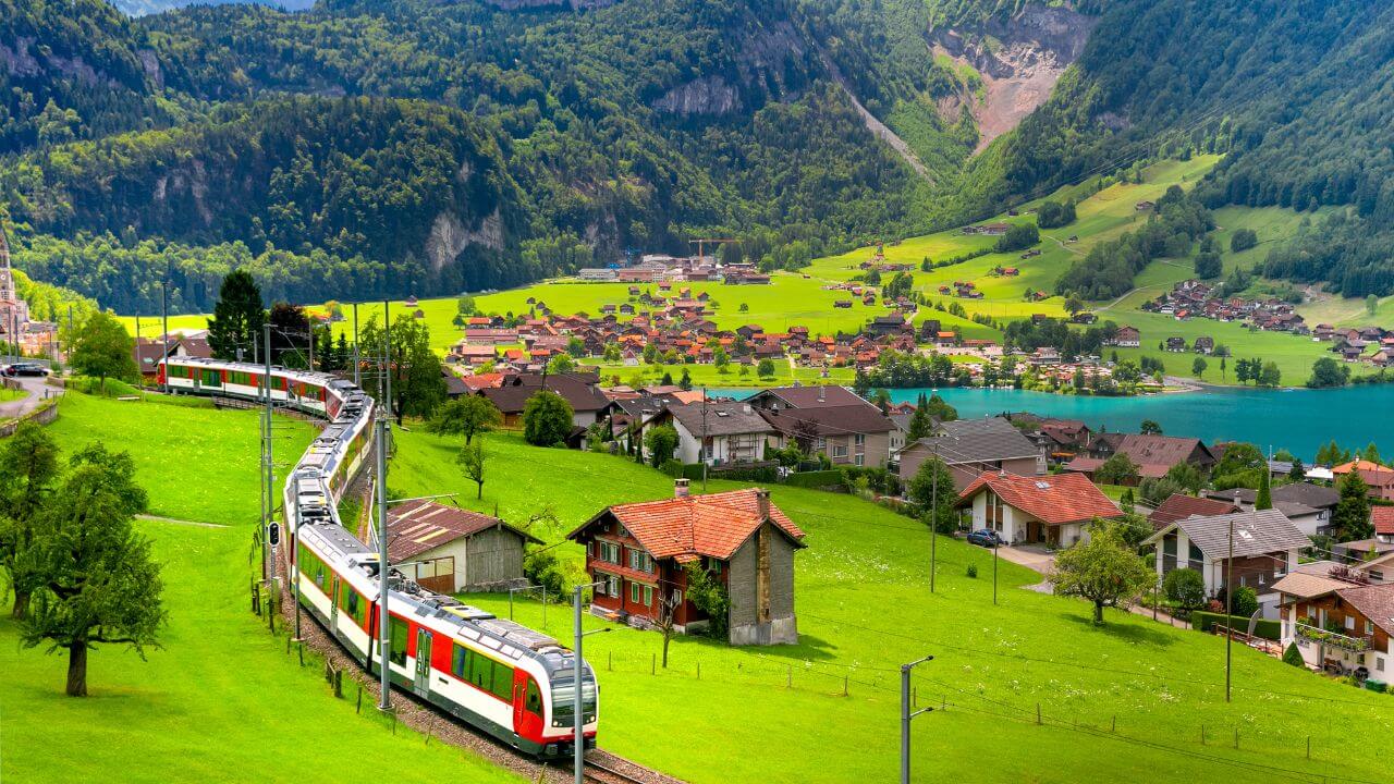 train with the swiss alps in the background