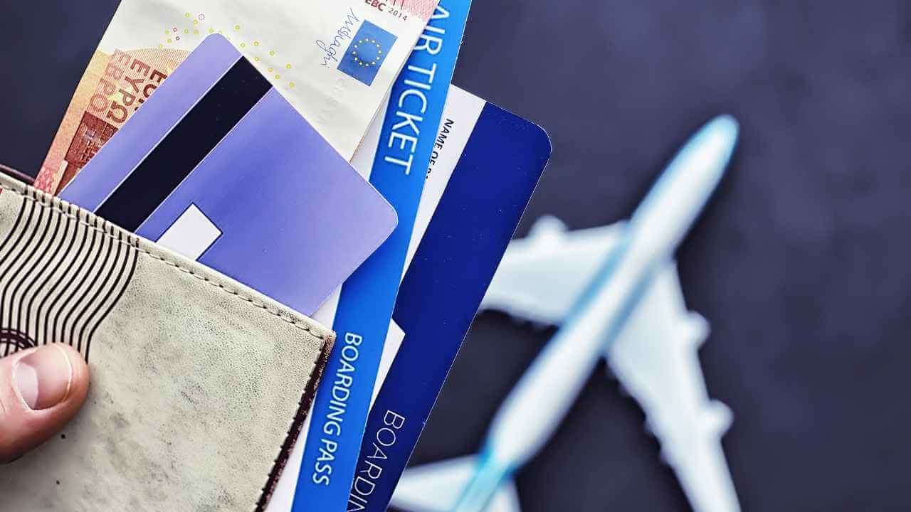 airline tickets, credit cards and money in a wallet