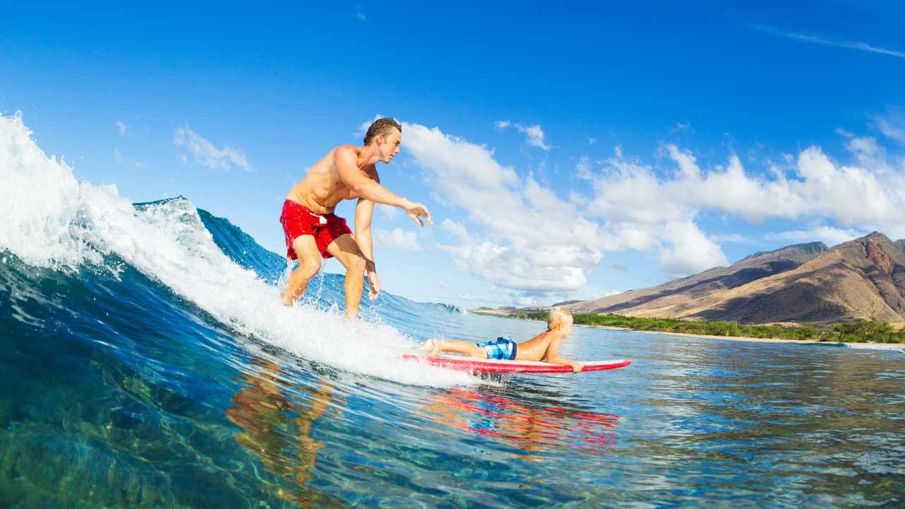 family surfing in hawaii