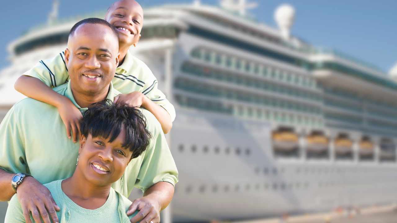 mom dad and son in front of a cruise ship