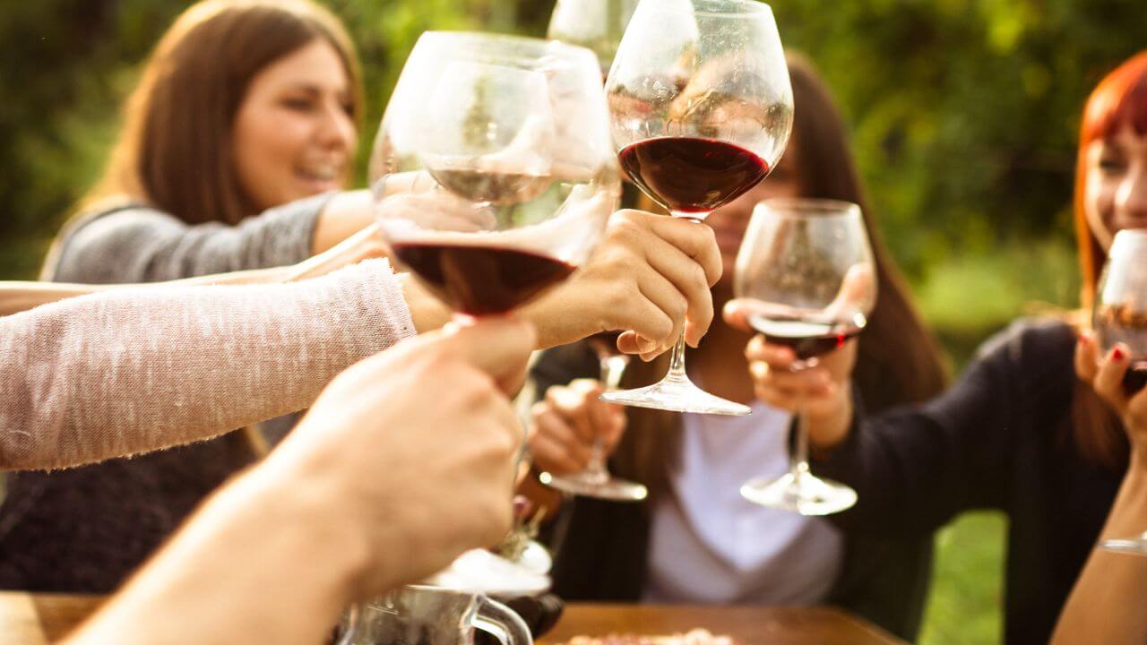 people cheering with wine