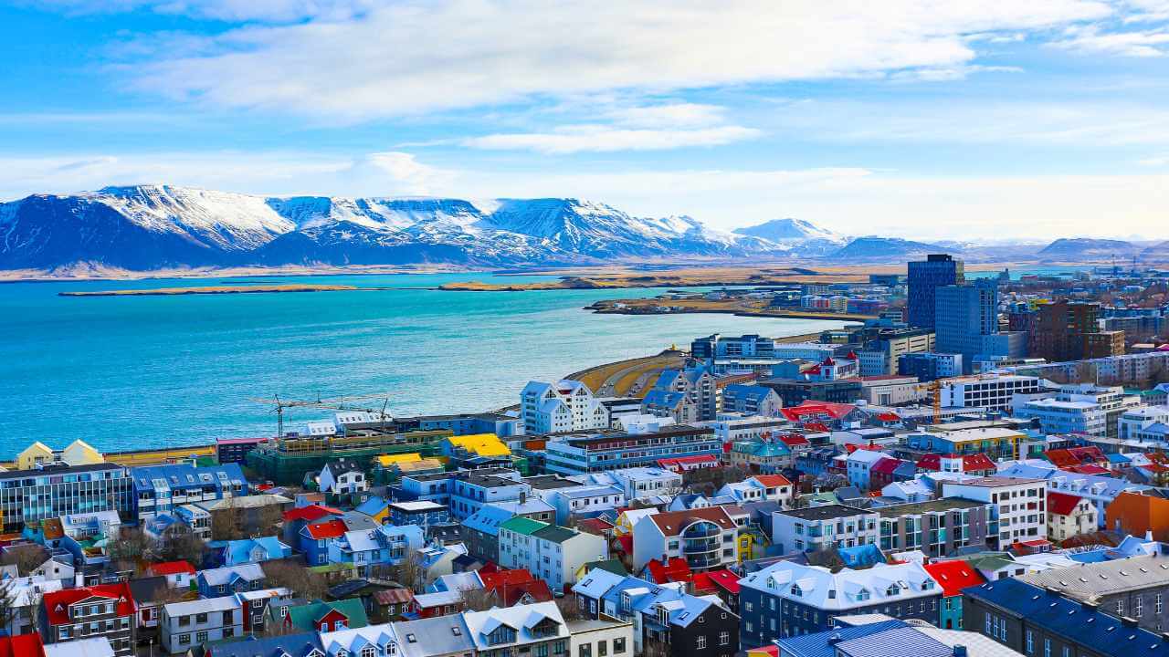 aerial view of reykjavik iceland, colorful house and mountains in the background