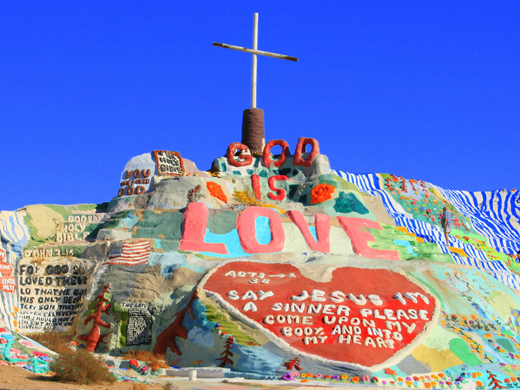 Salvation Mountain is a colorful artificial mountain north of Calipatria, California, near Slab City. It is made from adobe, straw, and thousands of gallons of paint.