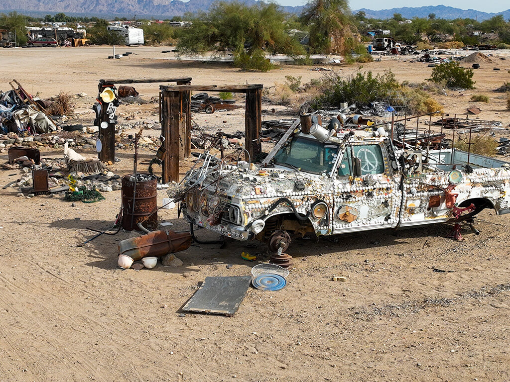 Slab, City, December 27, 2023: The Famous Slab City, California, where an independent community has grown to take over the Dunlap Army Base Site looking at a wrecked car turned into art,
