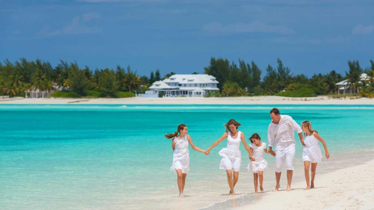 white family walking along the beach in the bahamas
