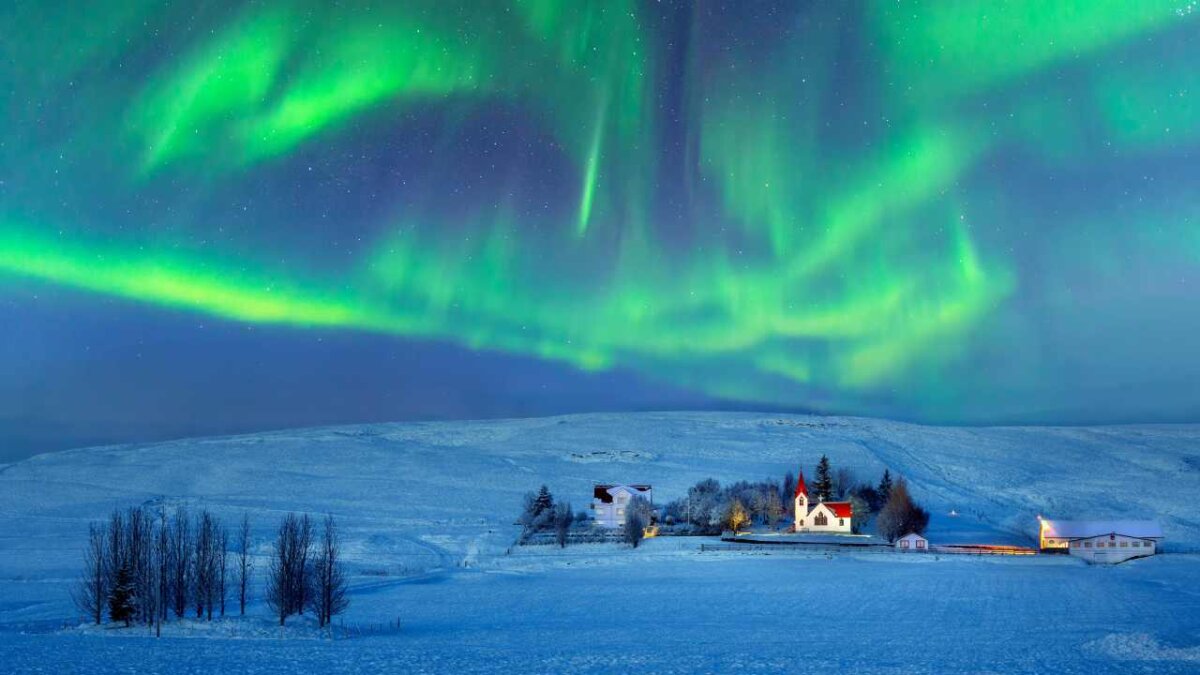 view of northern lights in icleland, green and blue lighting up the sky